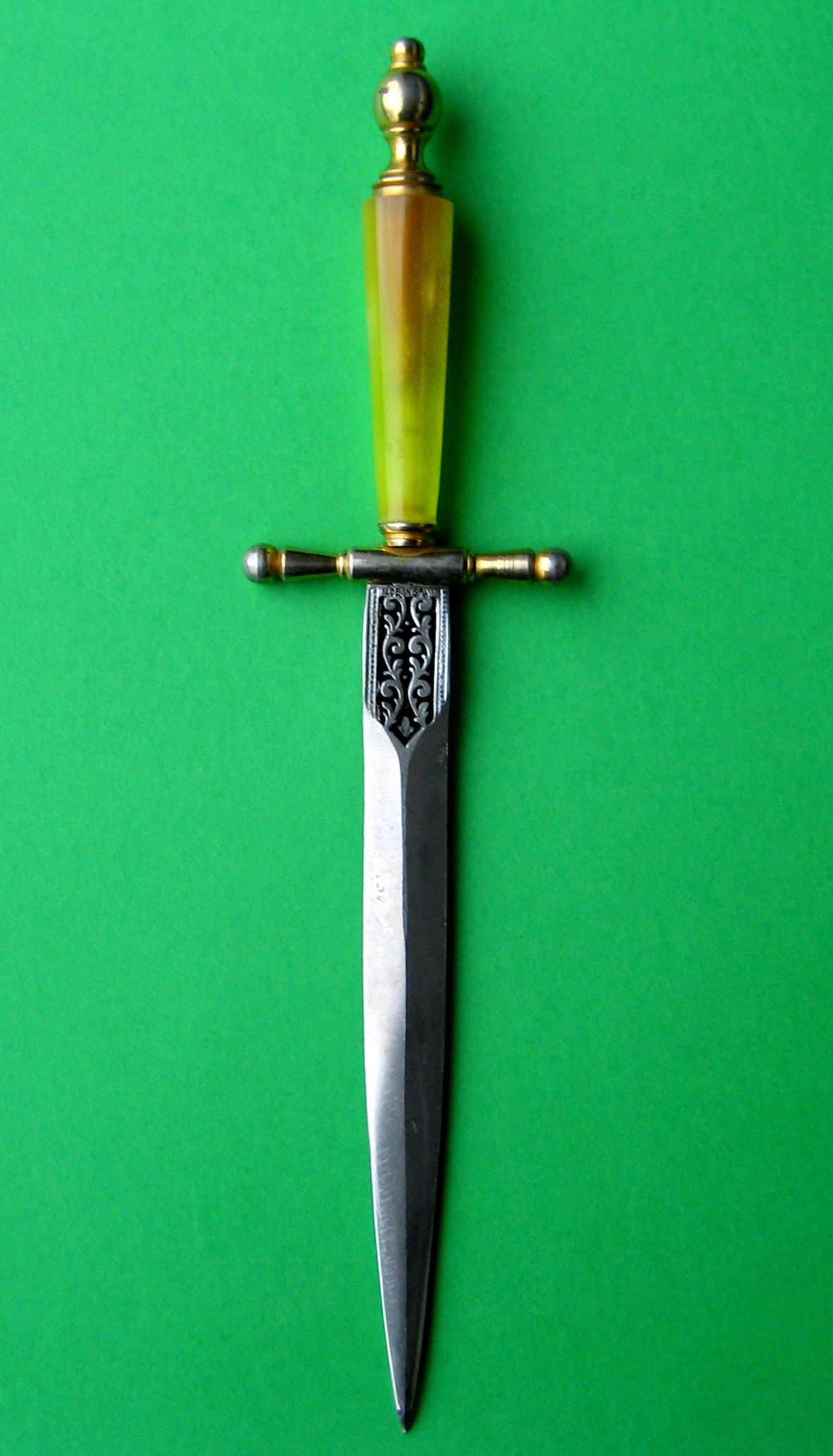 a large knife stuck into the side of a green surface