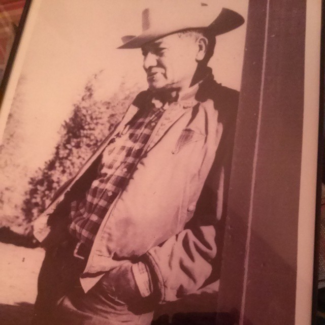 an old po of a man wearing a cowboy hat and plaid shirt