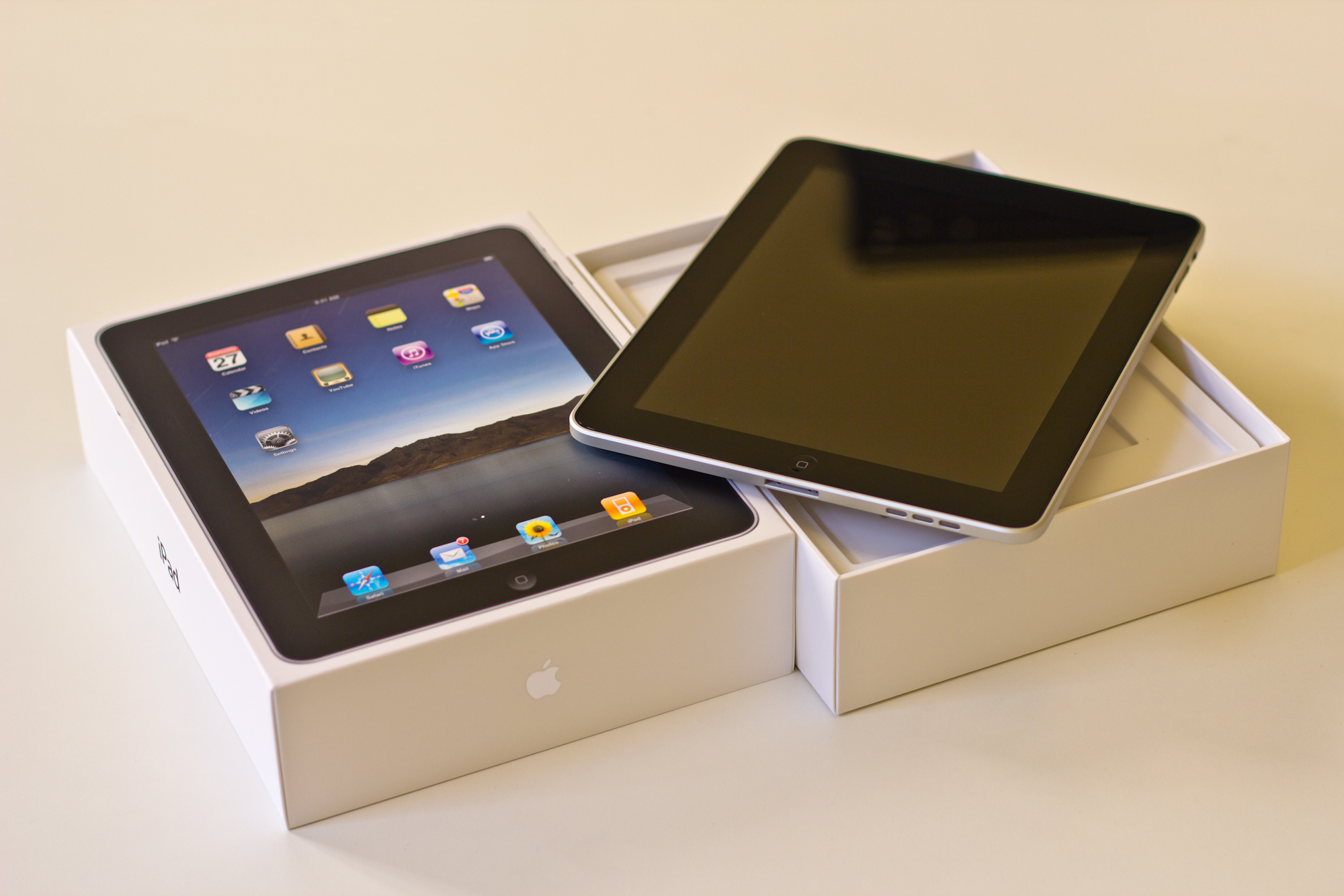 an ipad and a box on top of a white table