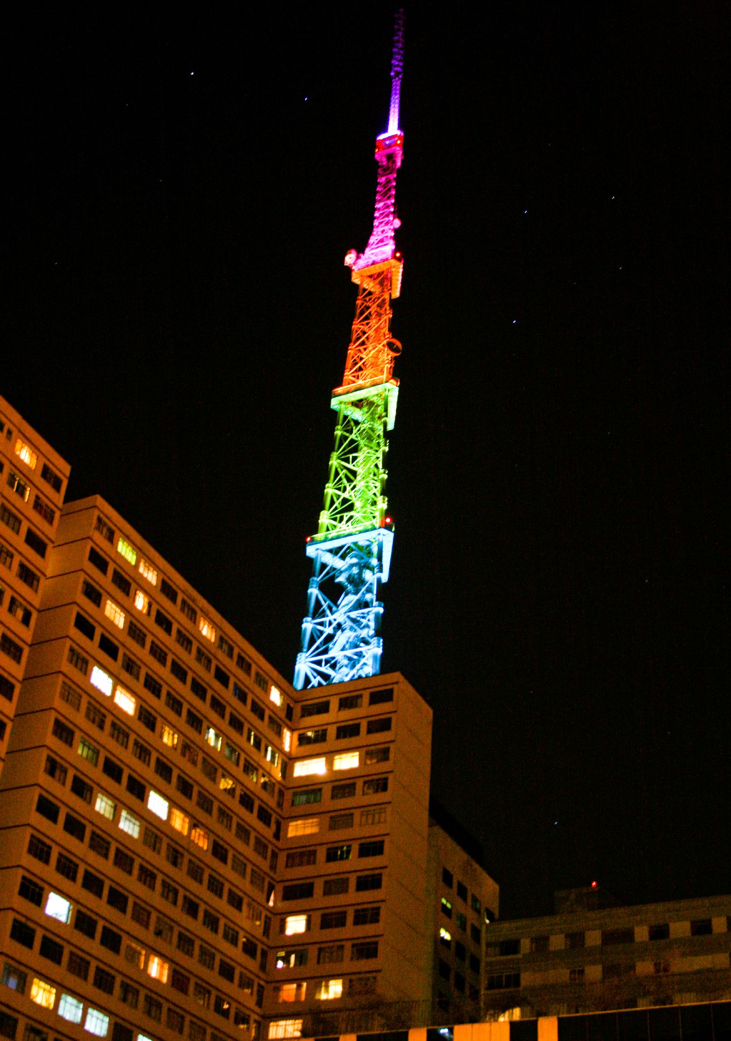 lit tower in the dark with many lights on