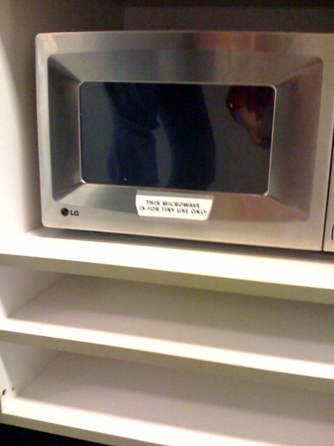a silver microwave with a person walking in it