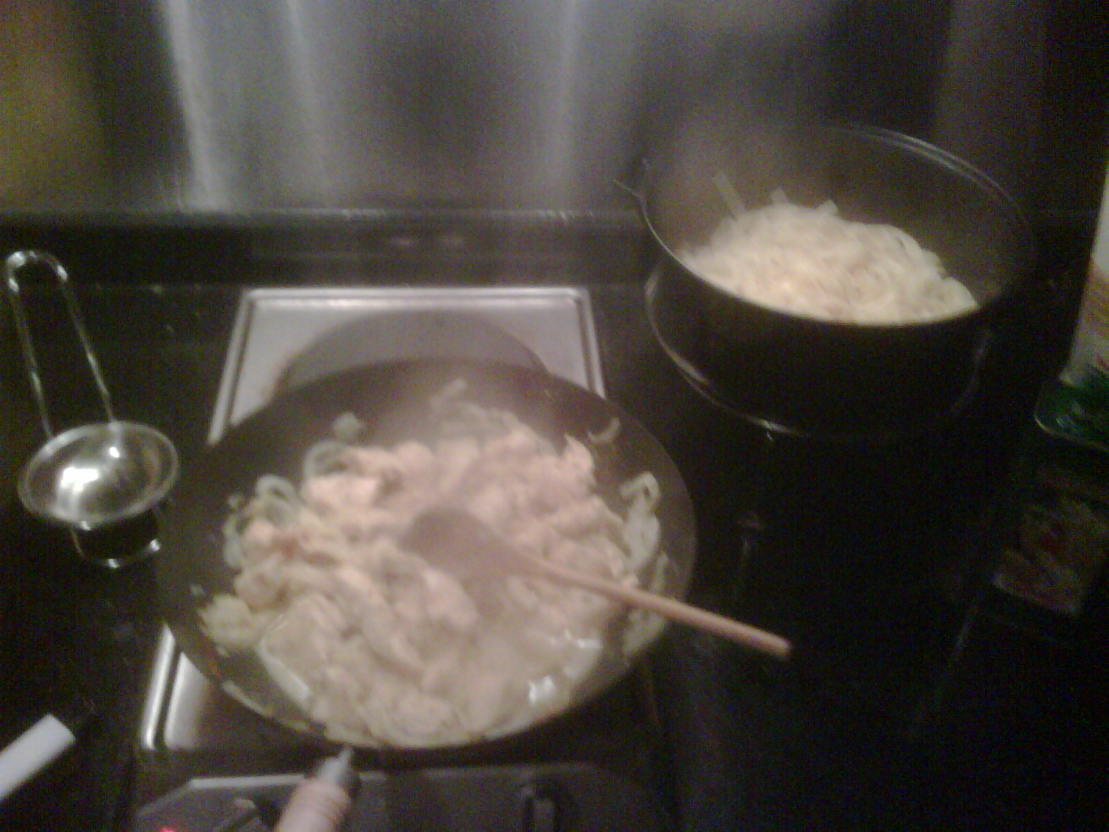 a pot full of chinese rice cooking on an stove