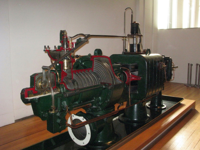 a black train engine on display on a wood table