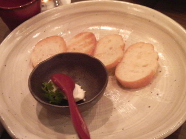 the plate has a spoon on it and four pieces of bread