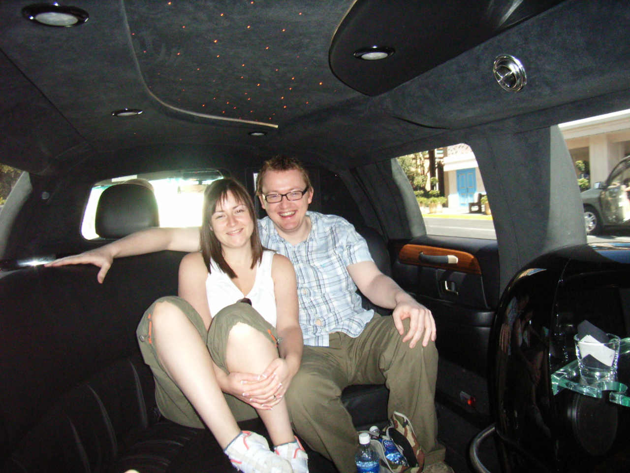 a man and woman in the back seat of a car