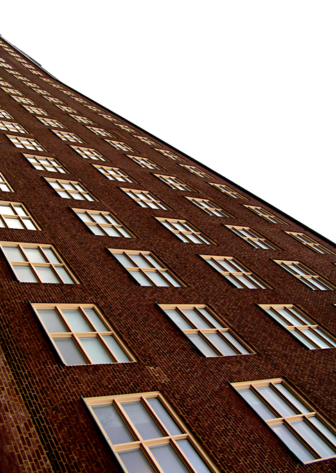 the top of a tall brick building with windows