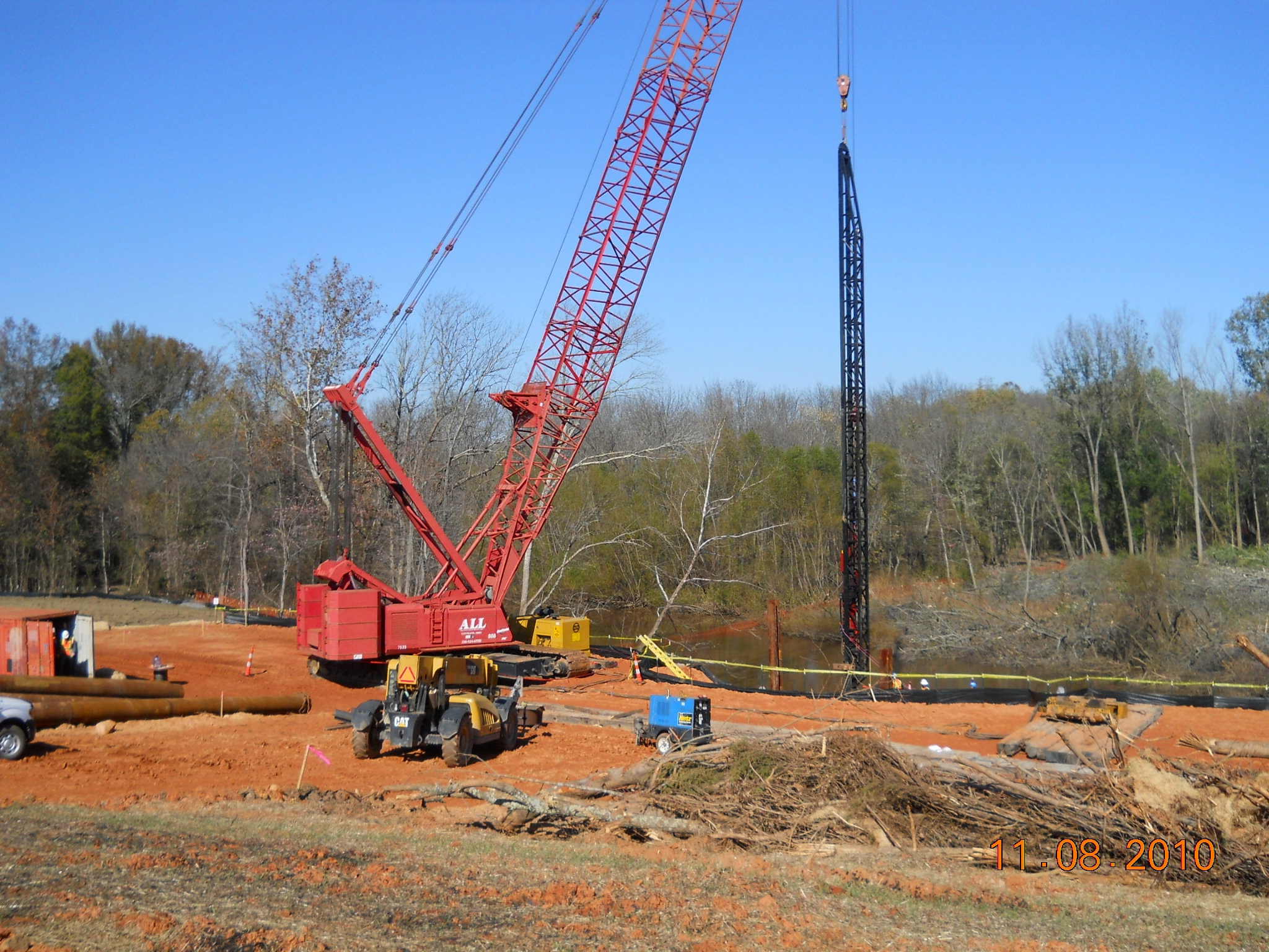 a big crane is next to some trees