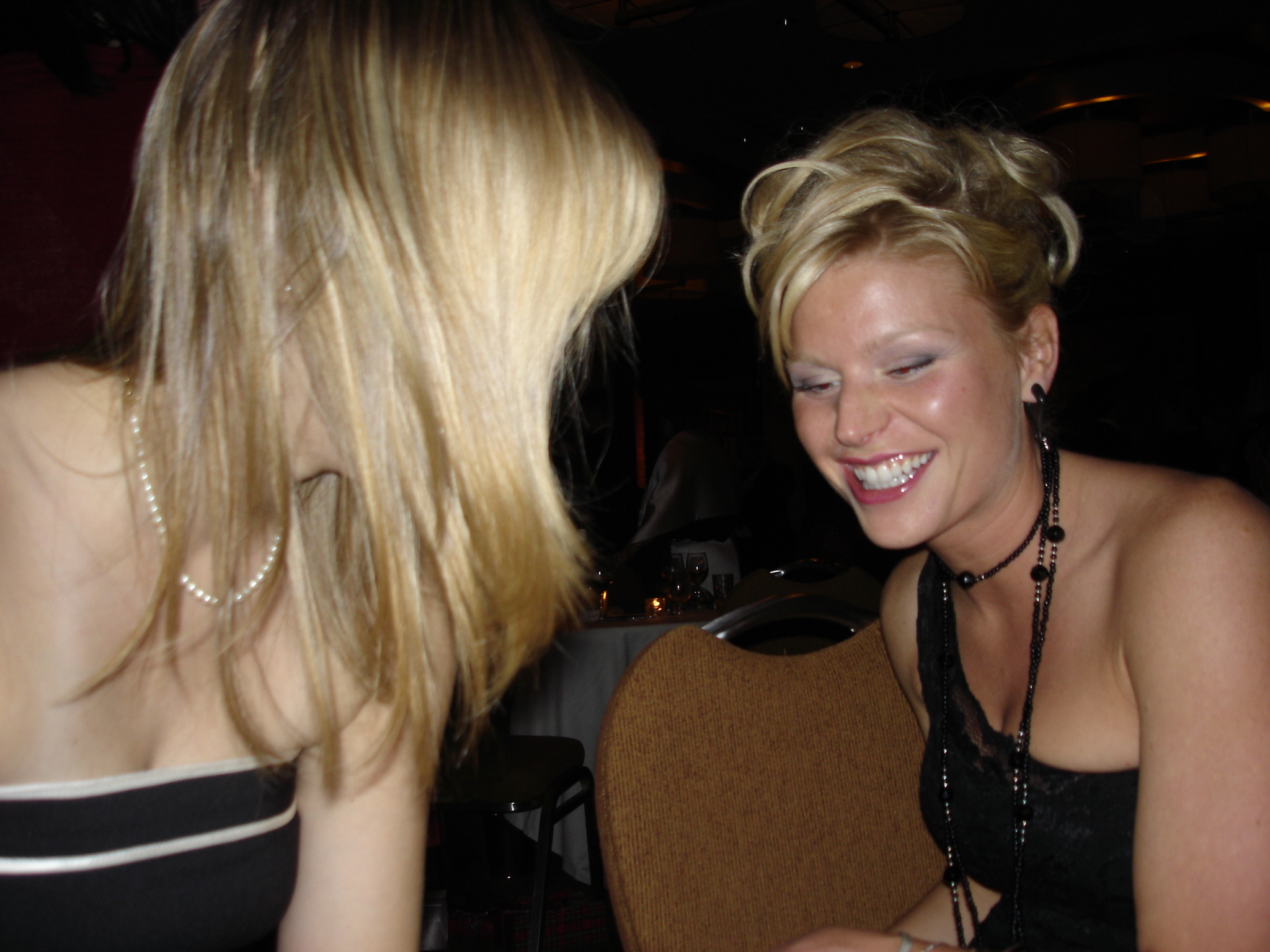 a woman talking to a young woman sitting next to each other