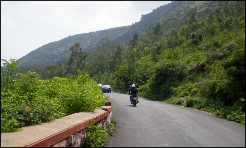a person riding a motorcycle on a country road