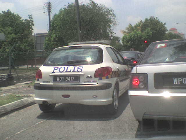 two cars parked in a lot with the word poll written on their windshield