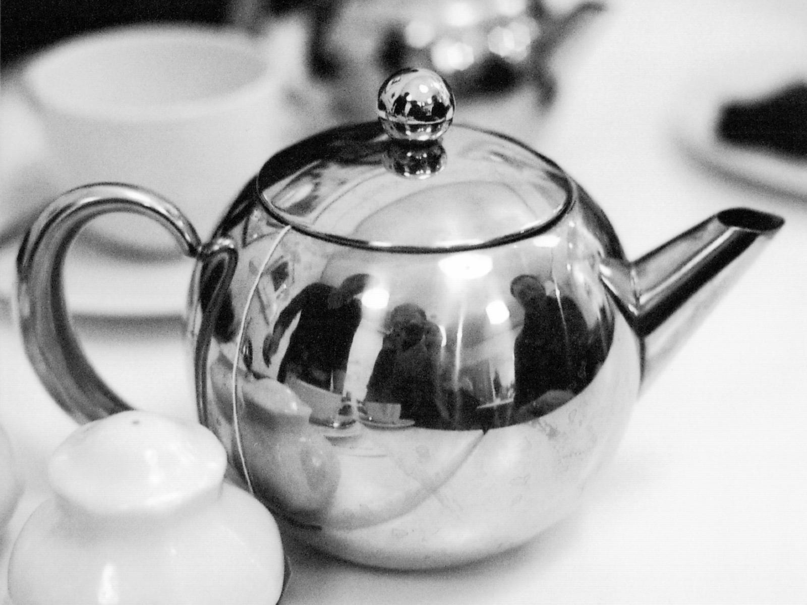 a silver tea pot sitting on a table