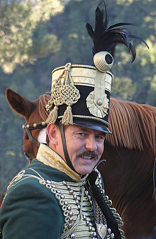 an image of a man wearing a hat on the front of a horse