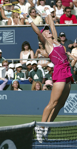 a woman in pink is playing tennis and about to hit the ball