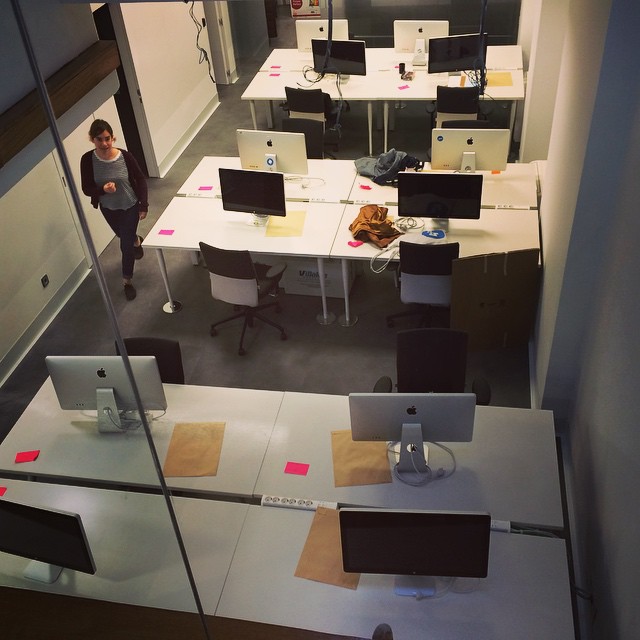an office space with cubicles and tables
