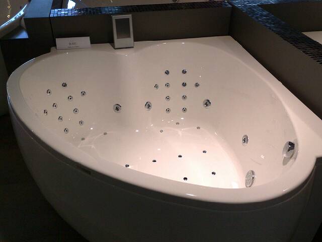 the bathtub sits on the counter with the water running