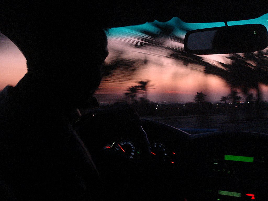 the view from inside the car with the dashboard and driver's seat illuminated by green lights
