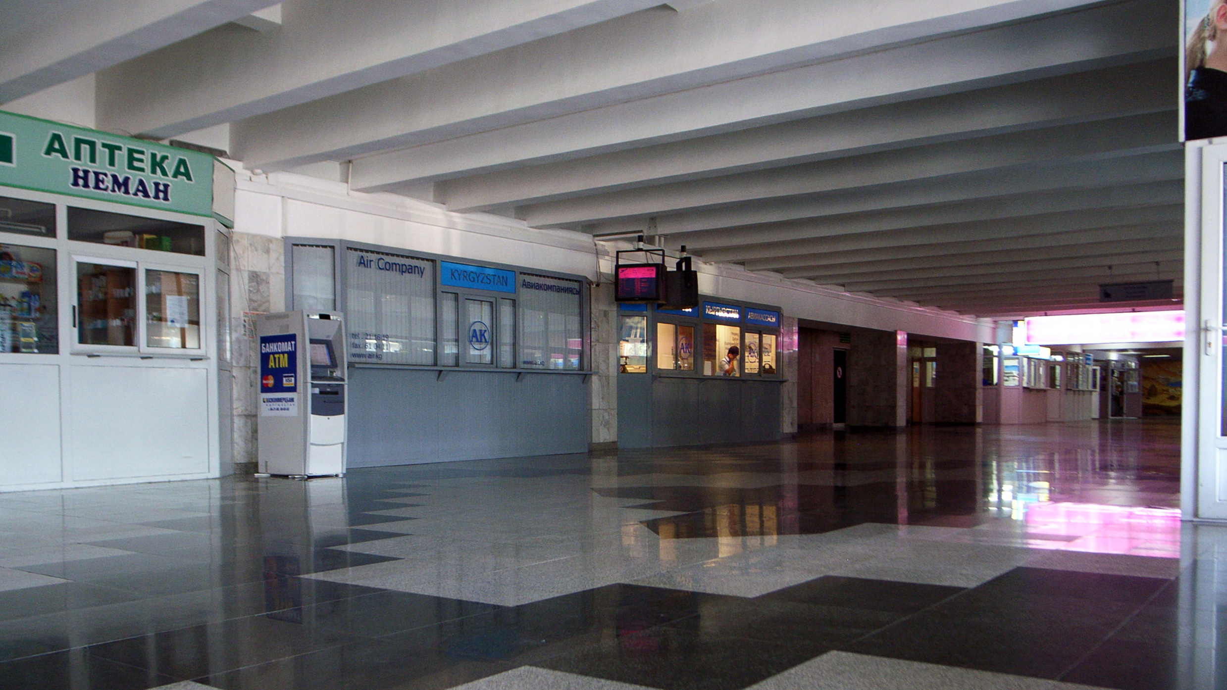 an airport terminal with a checkered floor and wall