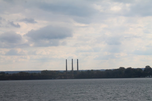 a large lake surrounded by tall stacks of smoke