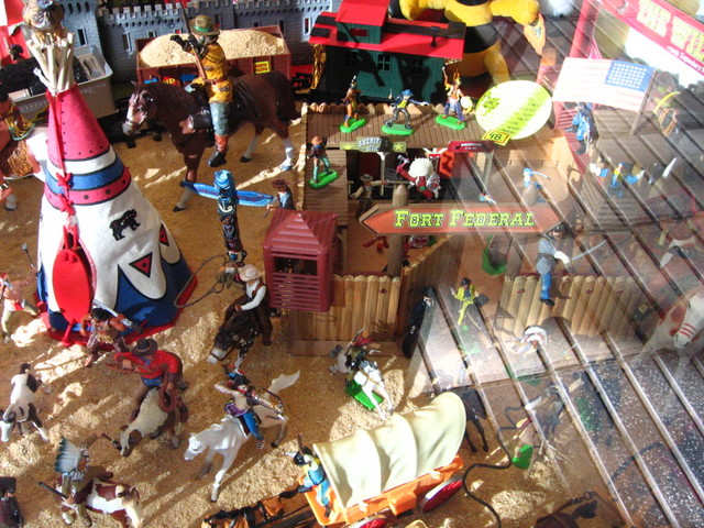 a collection of toy figurines and people on a street