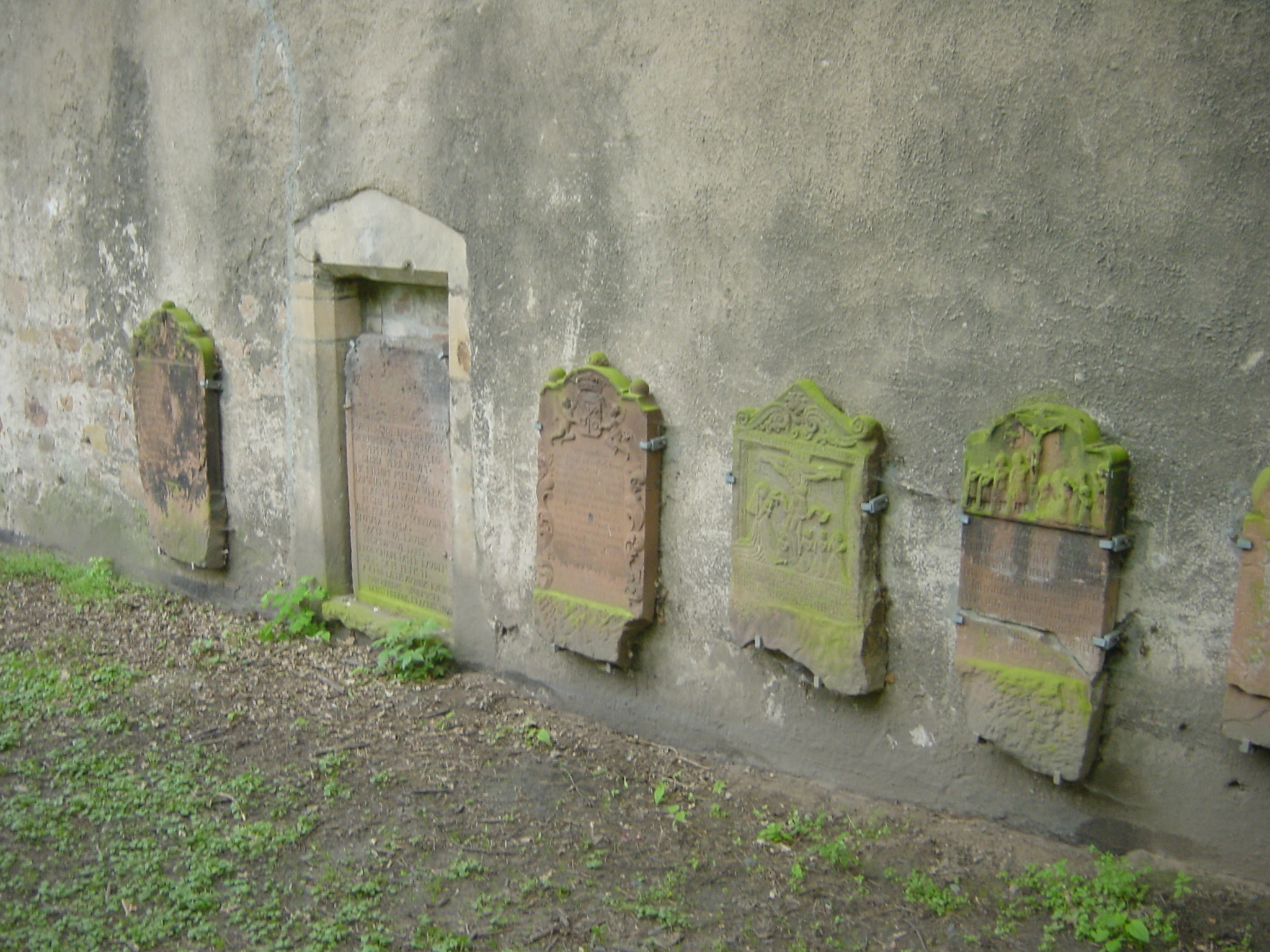 a row of stone tombstones placed near each other