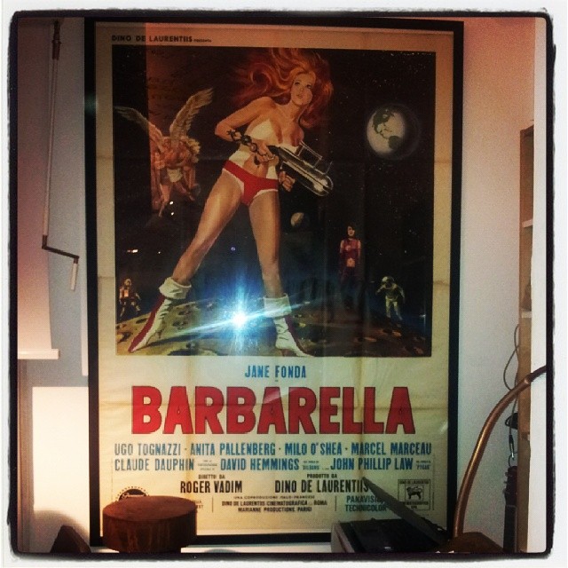 a barbarella movie poster hanging in a corner