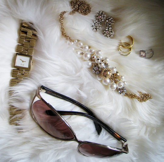 a few pieces of jewelry laid out on some fur