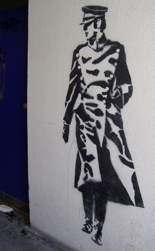 the graffiti art depicts a man wearing a coat