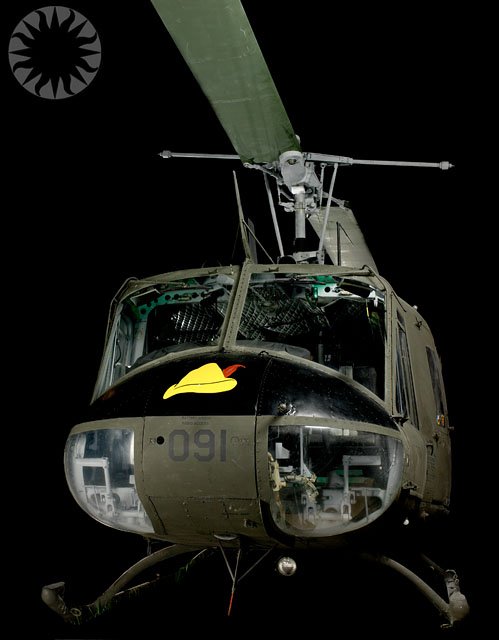 a military helicopter on display in a dark background