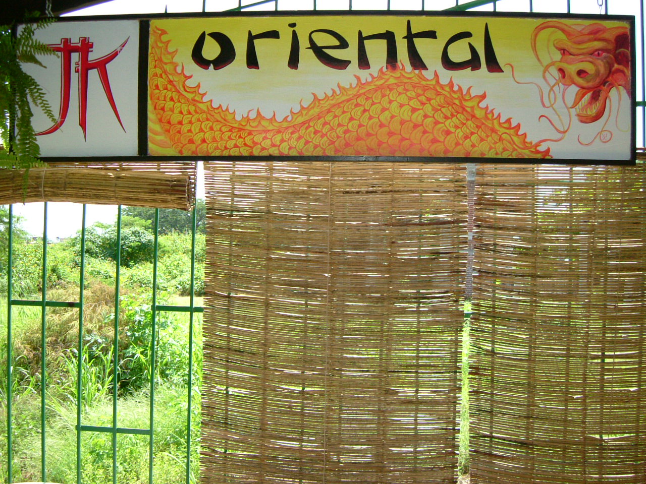 a window covered in bamboo and an oriental sign