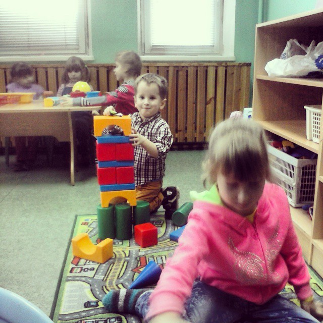 s playing with toys in a play room