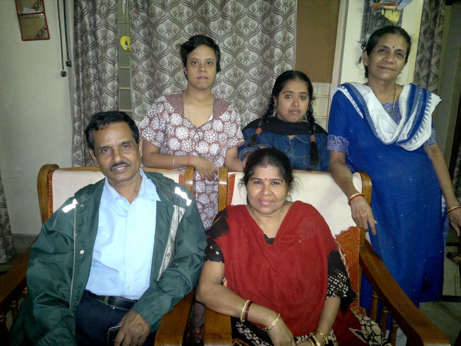 a family of three are sitting together on a bed