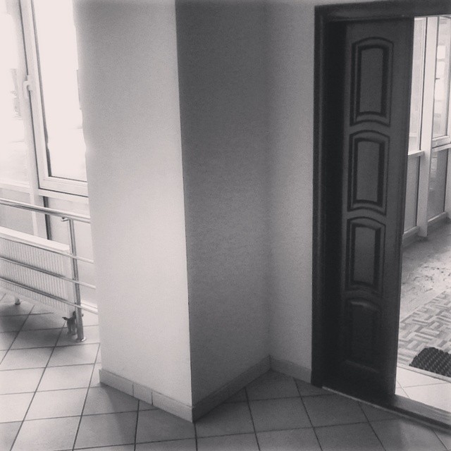 a black door is open and sitting in a corner