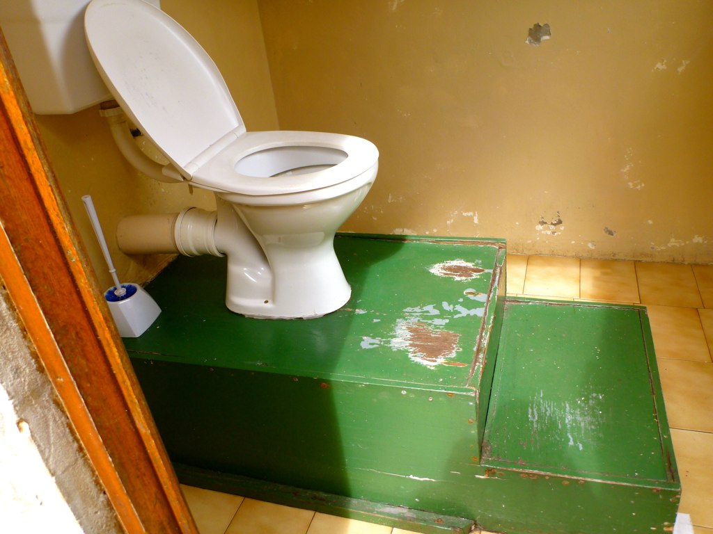 a toilet that is sitting on some green boxes