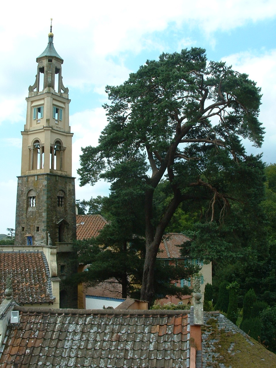 an old church is shown next to a tree