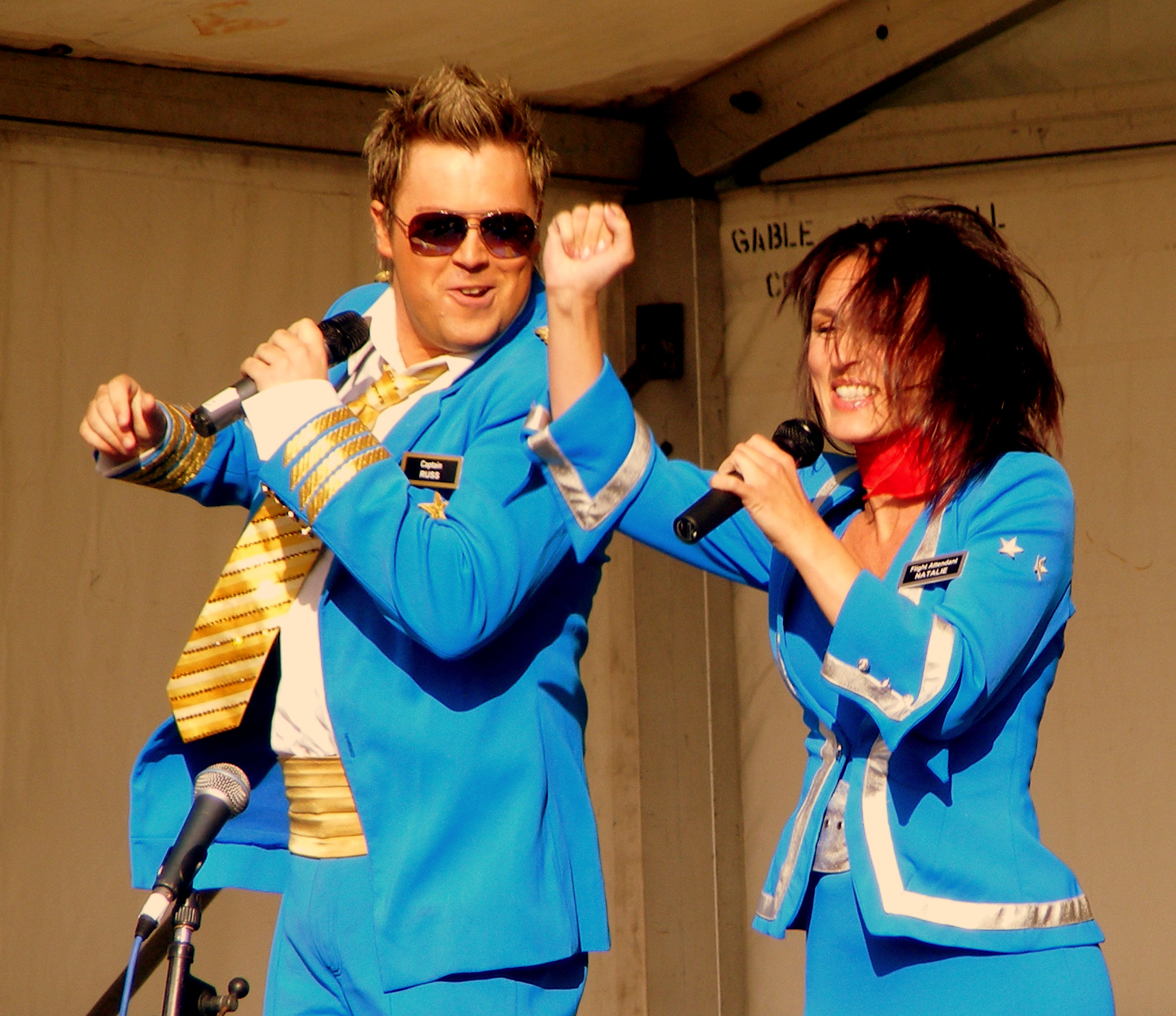 man and woman in blue suits performing on stage
