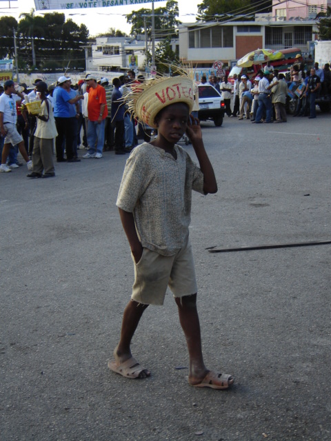 a boy in a mexican hat walks on the street
