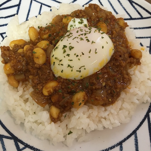 a plate with rice, beans and a poached egg on top