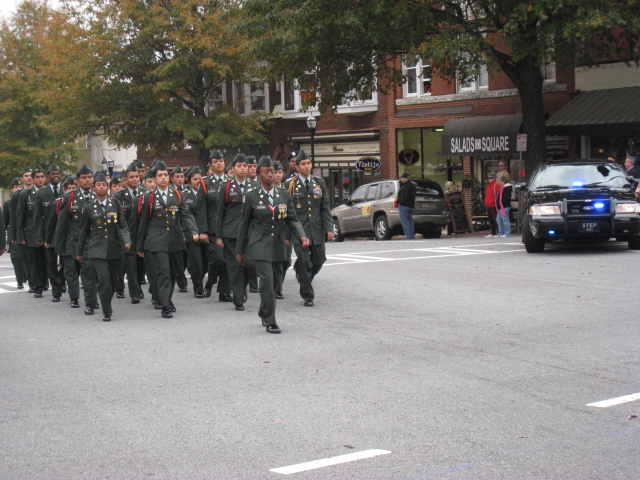a group of uniformed men walking down the street together