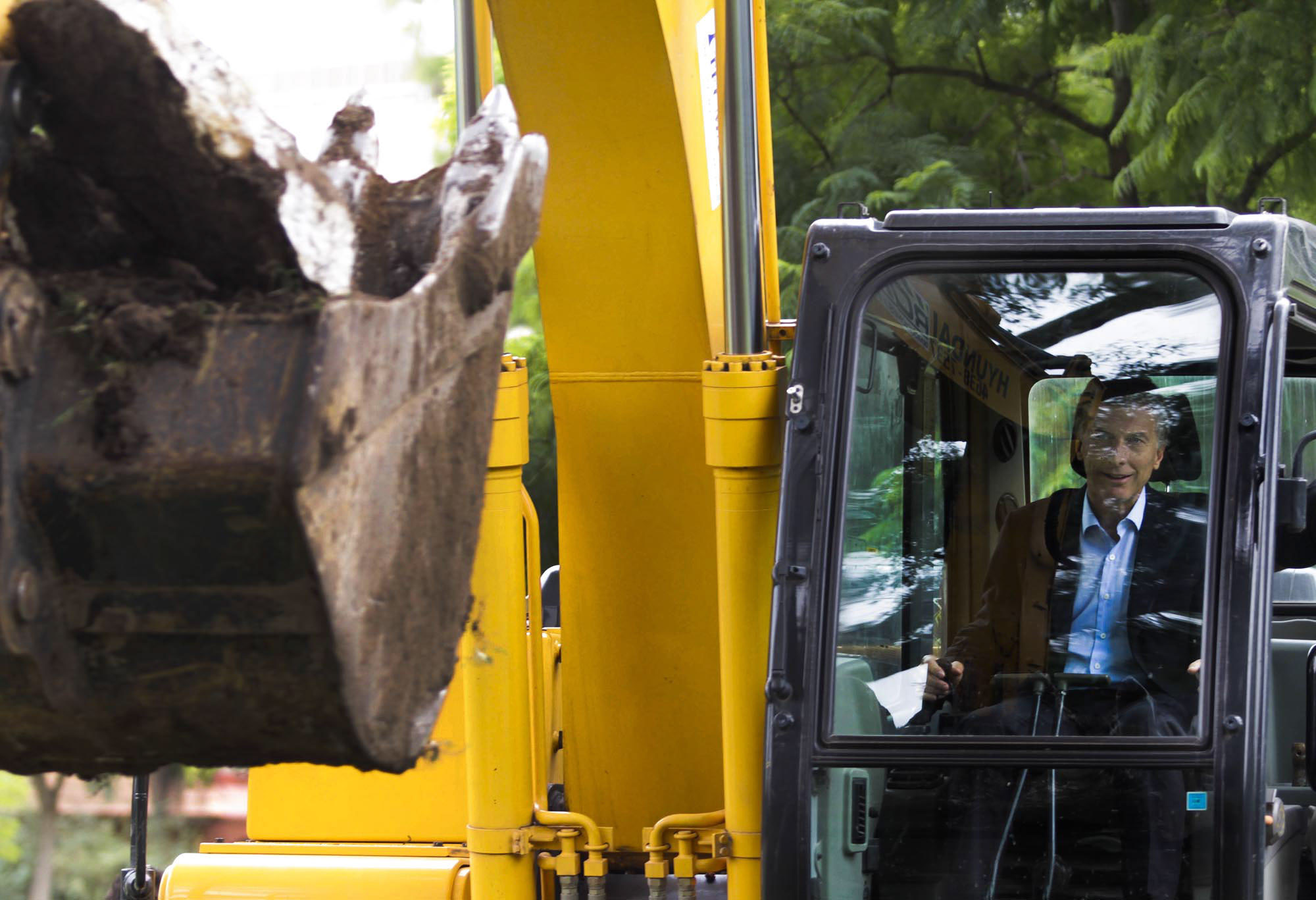 a man sitting in the driver's seat of a construction vehicle