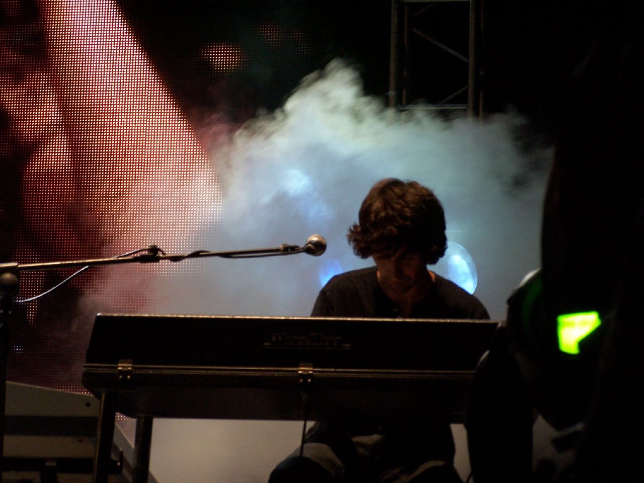 a man is sitting down playing a keyboard