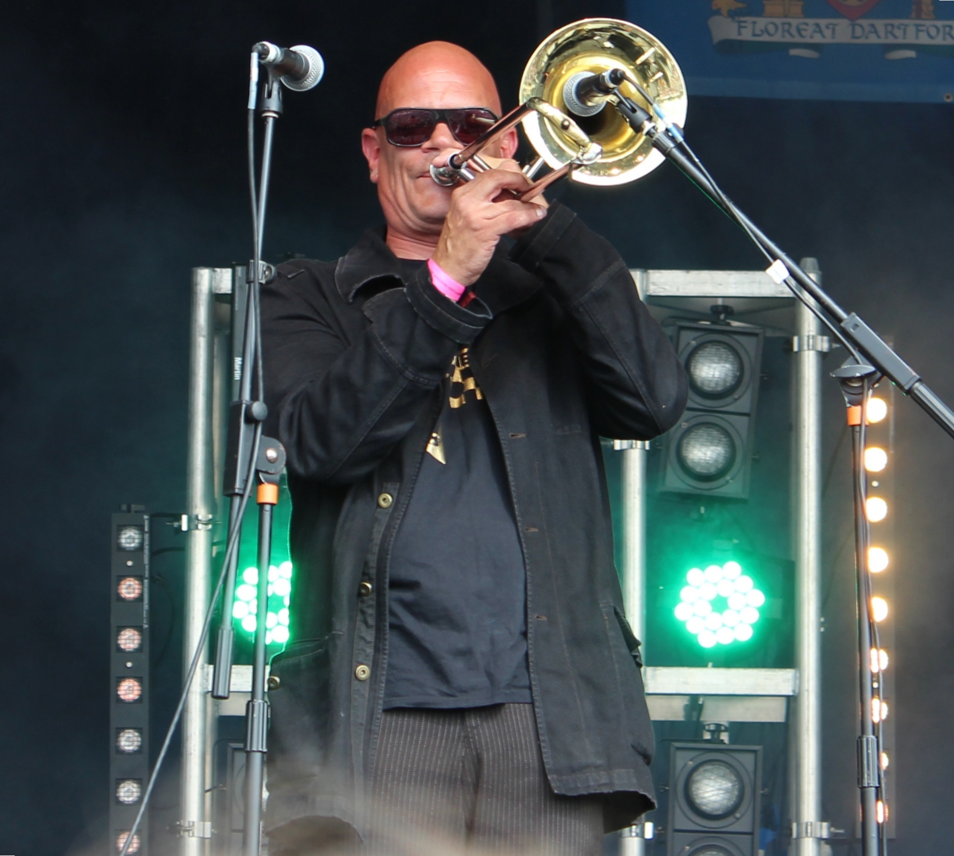 a man that is standing on a stage with a trumpet