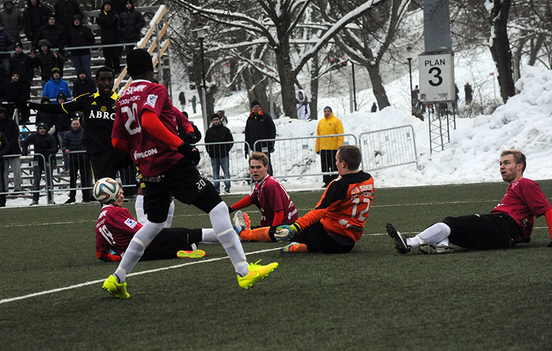 soccer players are playing outside on a snowy field