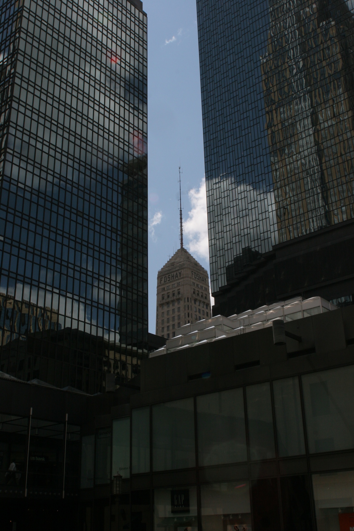 a tall building surrounded by some other tall buildings