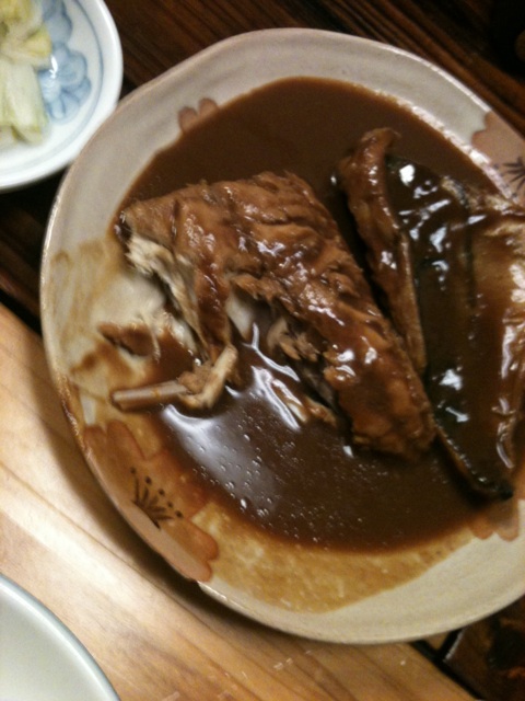 a plate topped with steak and gravy covered in sauce
