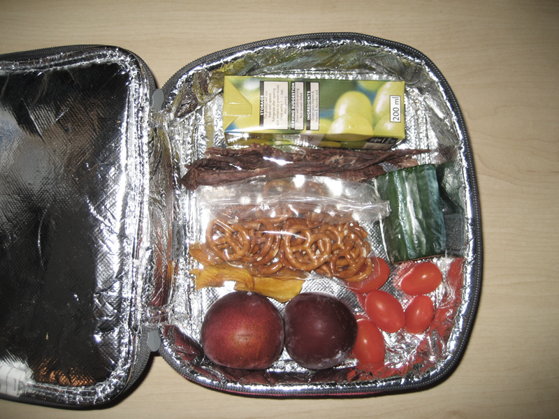 an aluminum bag filled with assorted food on top of a table