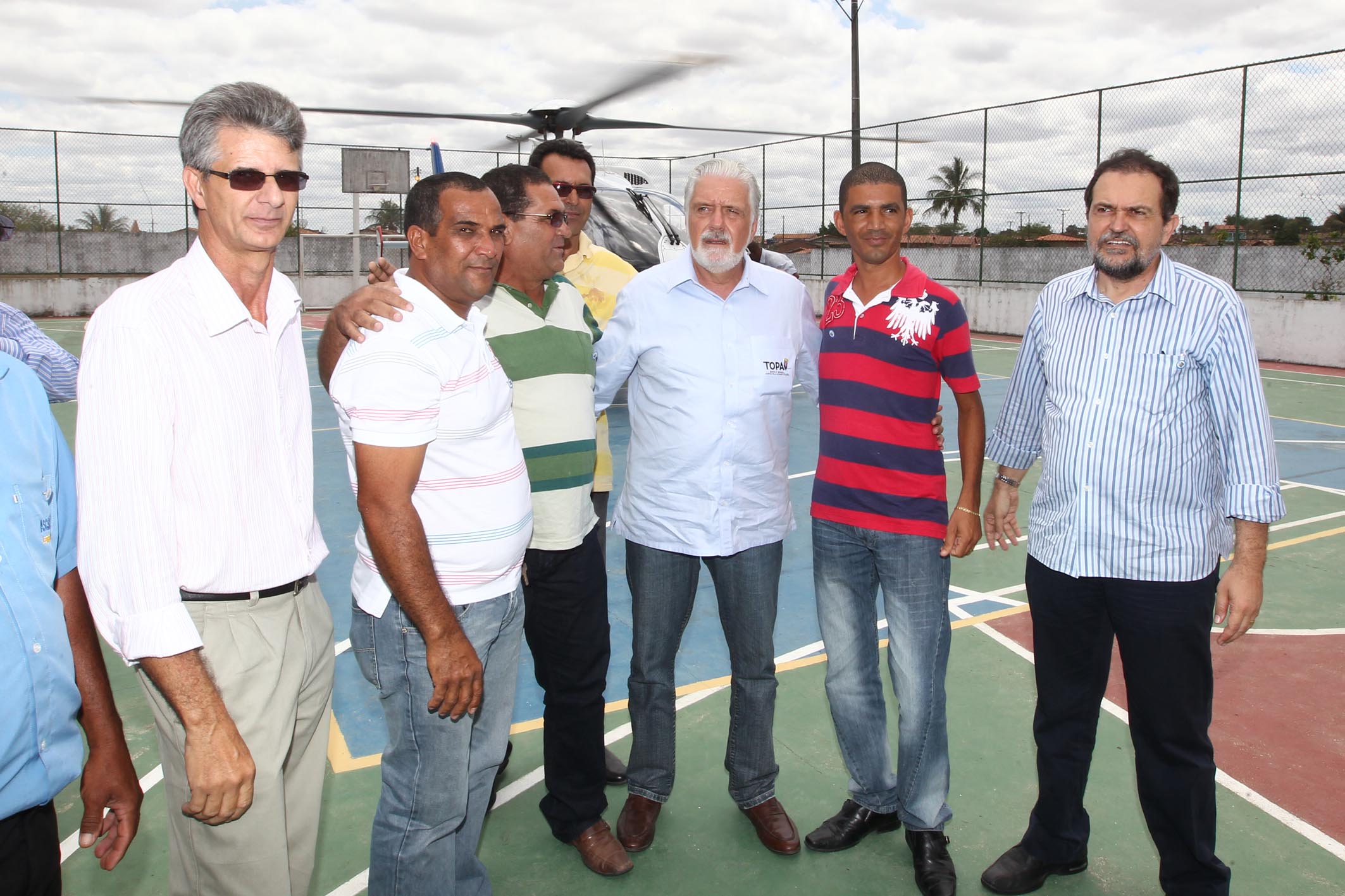 a group of men are standing next to each other on a tennis court