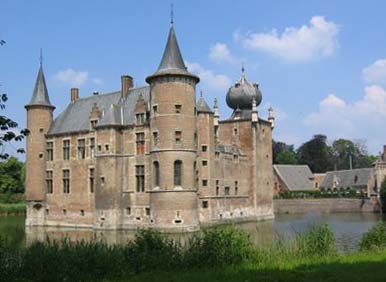 the large brick castle has towers and arched windows