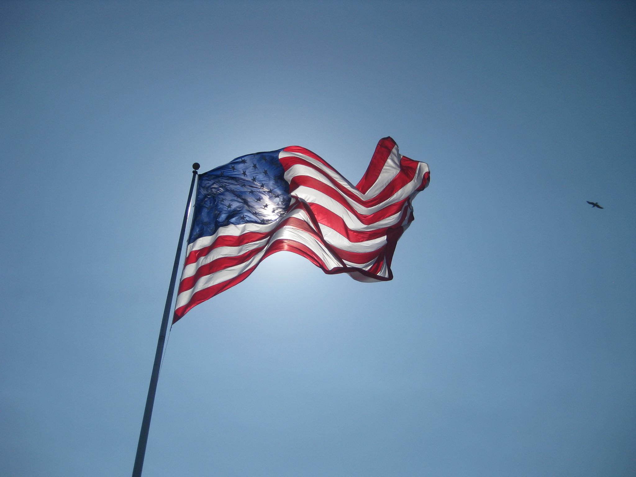 an american flag waving in the wind on a clear day