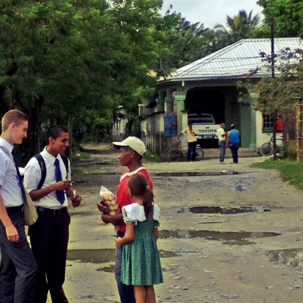 three people and a little girl stand together