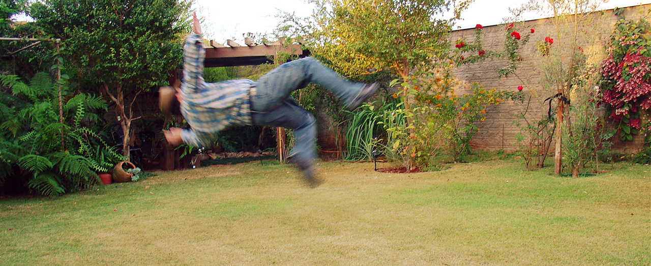 an image of a guy doing a stunt in the back yard